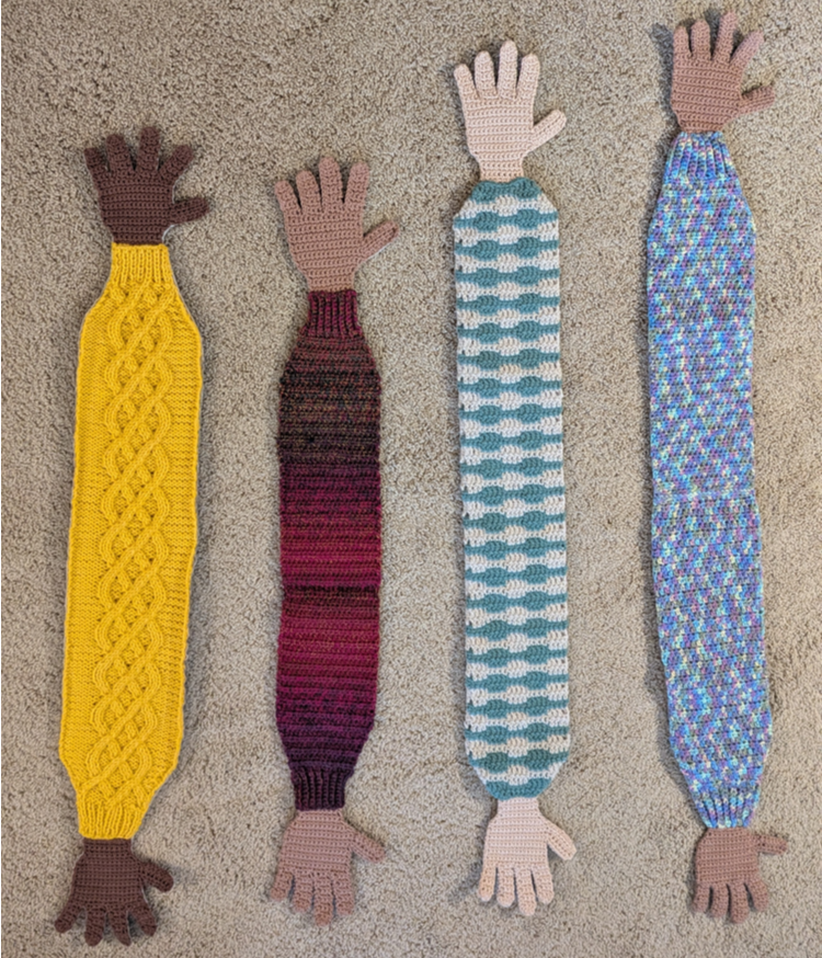 four pair crocheted hands joined by crocheted and knitted sleeves